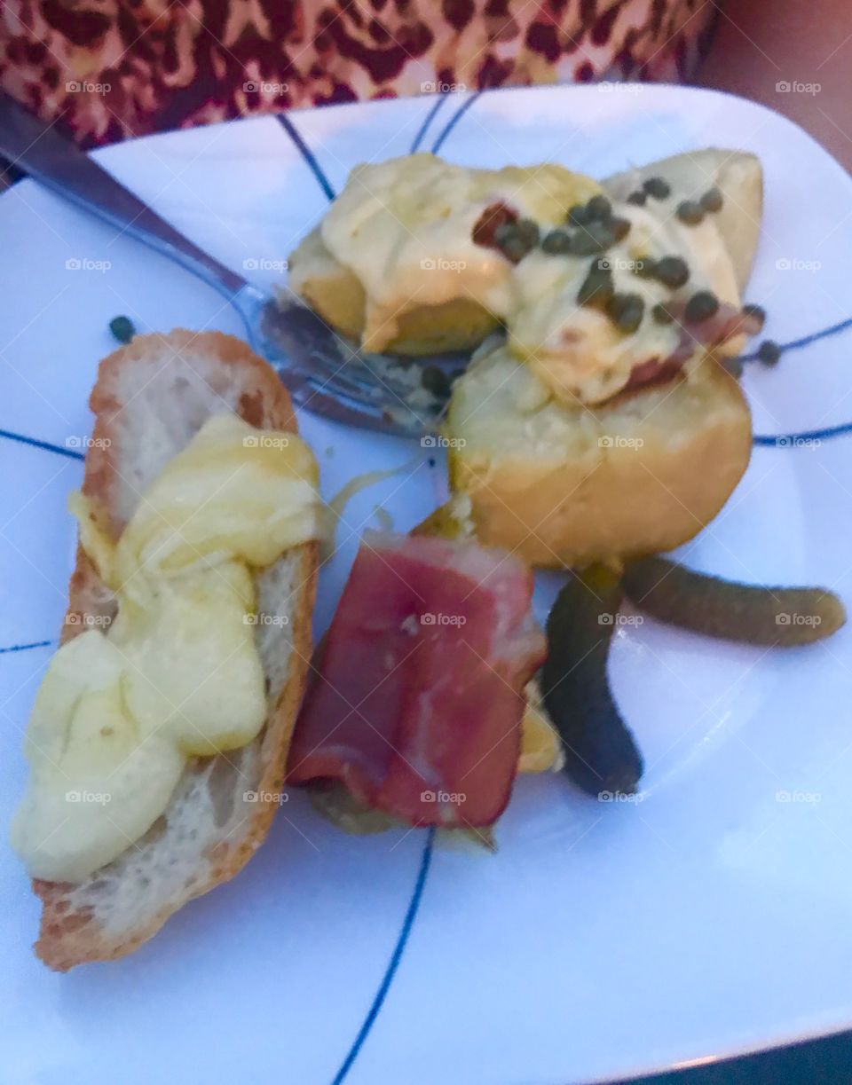 Racclette, cheese, melted, Switzerland, capers, prosciutto, French, feast, good eating, gourmet, delicious, racclette grill, Crusty bread, sweet pickles and meats, anti-pasta,