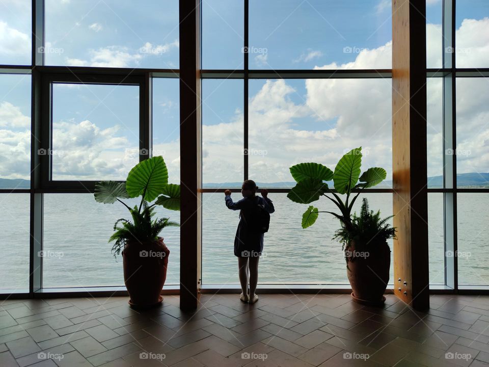 In front of the big windows in the museum