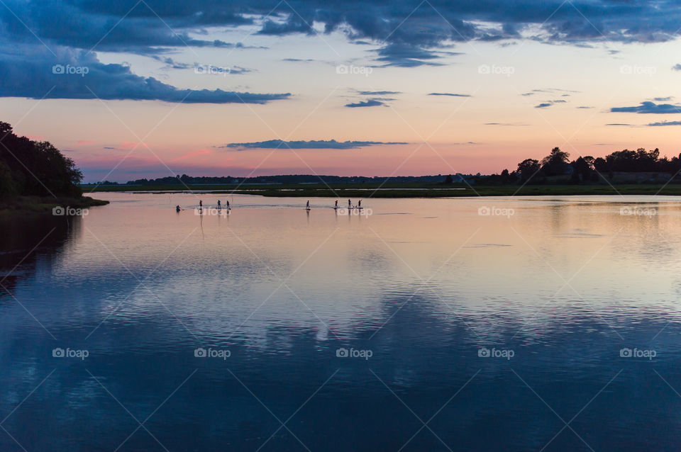Paddle boarding . Late night paddle boarders in Connecticut 