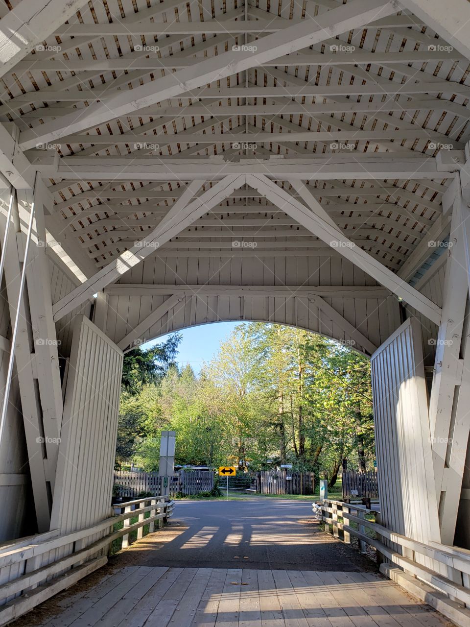 The view from inside a short covered bridge in Western Oregon on a sunny spring day. 