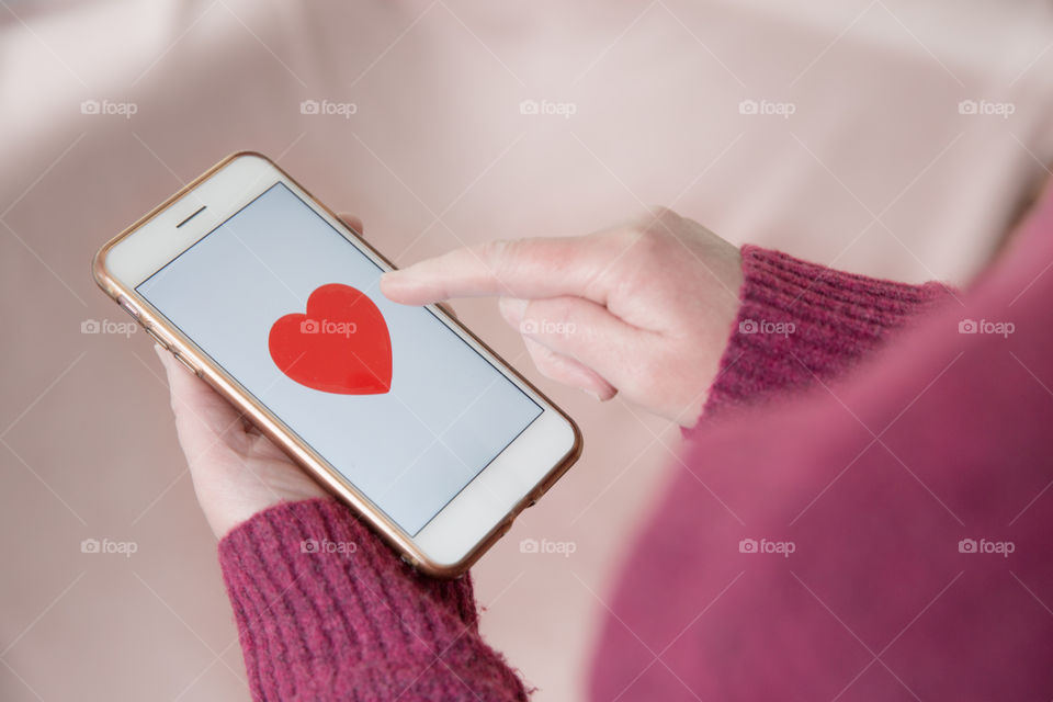 A single girl using her mobile phone to find love in an online dating app