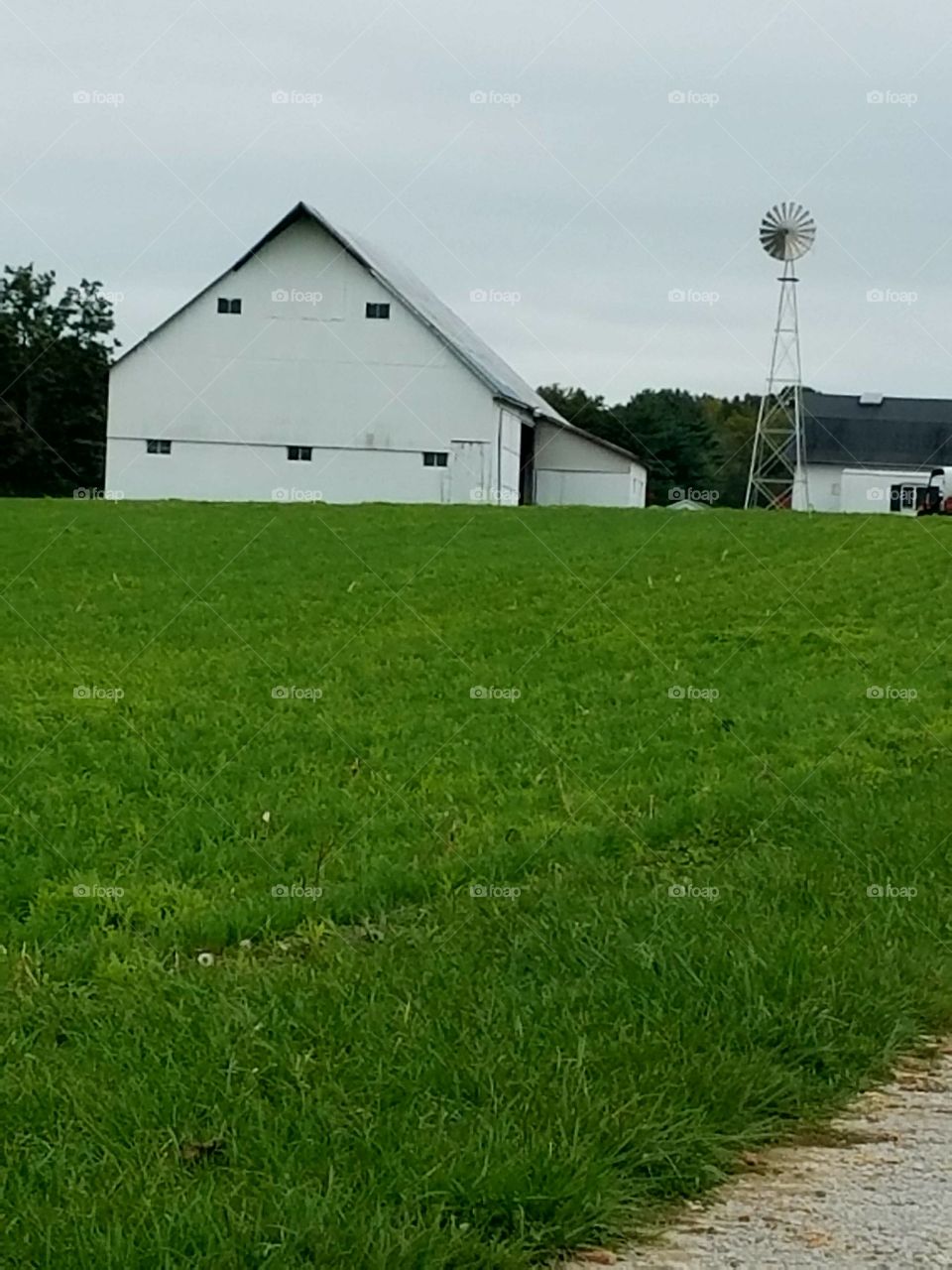 white barn with a windmill