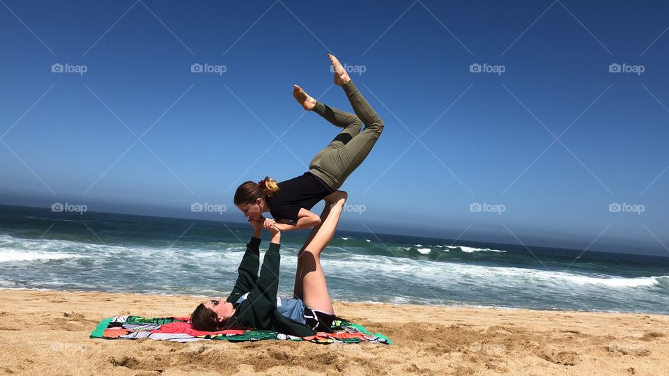 Two girls doing yoga poses 