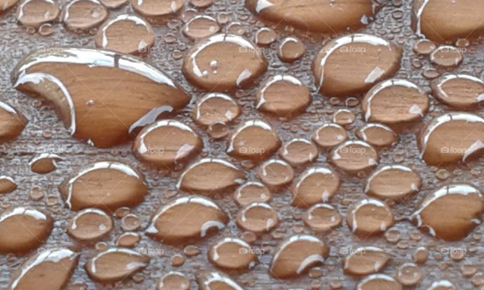 droplets. water drops on the picnic table