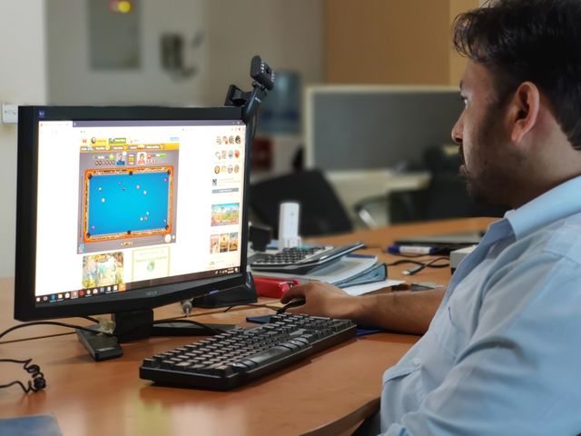 an office employee in front of his computer screen.