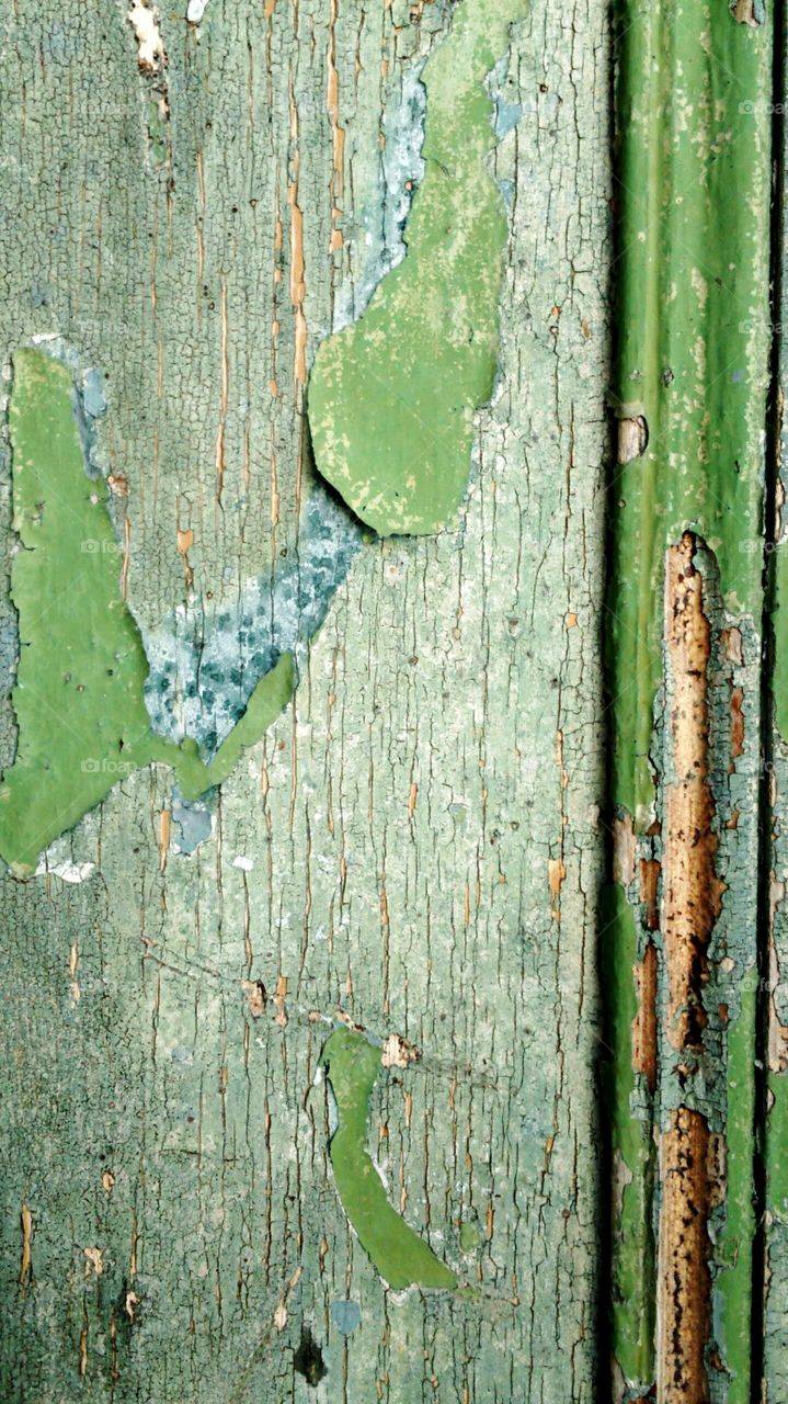 green for with peeling paint baked in the sun