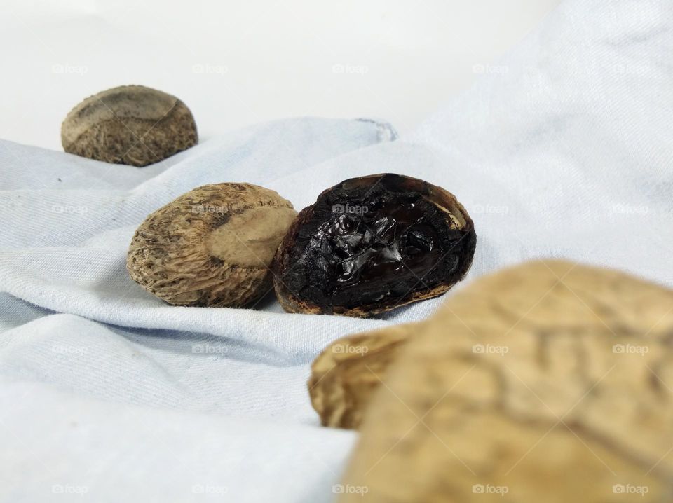 closeup of raw flesh of pangium or keluak seeds. this fruit has textured hard shell. Indonesian food ingredients