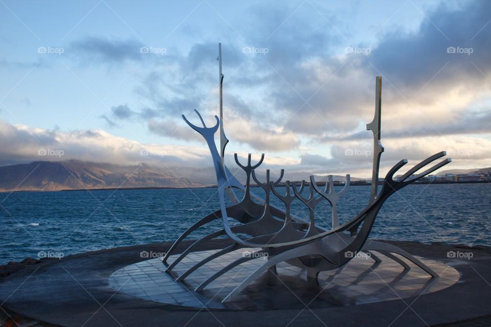 The Sun Voyager on an early morning in Reykjavik, Iceland with view on the ocean.