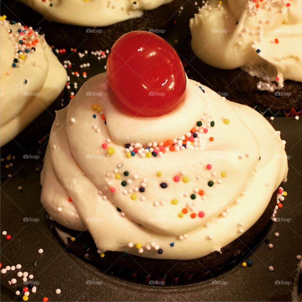 Yummy cupcake with a cherry on top. 