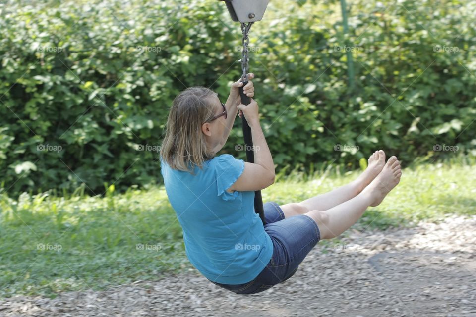 Zipline. Woman riding on zipline in adventure park