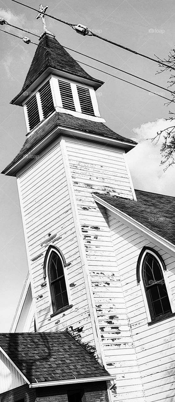 black and white filtered photo of an old wooden church tower with arched windows in Oregon