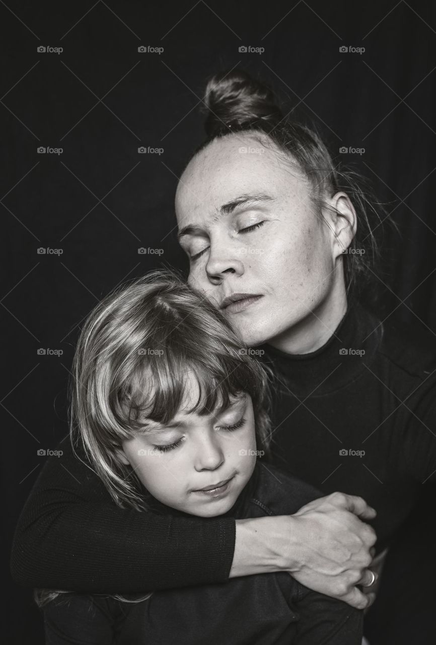 Mother hugs her daughter