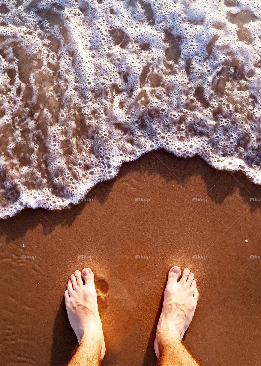 A man standing at the beach 