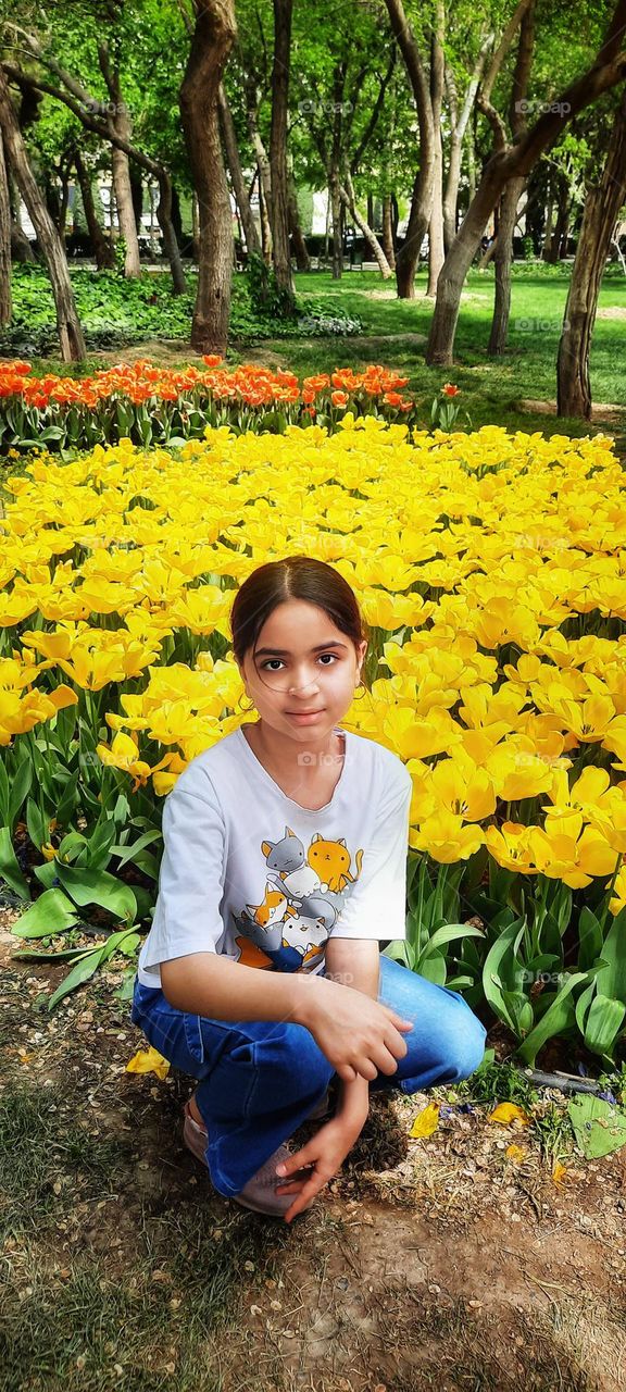 Like a dream,like an unspoken poem,she is not just sitting in the nature.The colors dance around her,the trees quietly create the shadow of love and the heart of the garden beats for her.As if spring itself has manifested itself in the form of a girl