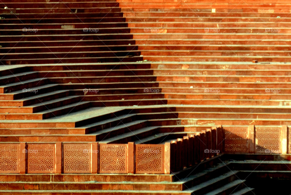 Stairs and steps of a heritage building and pond in afternoon lighting.