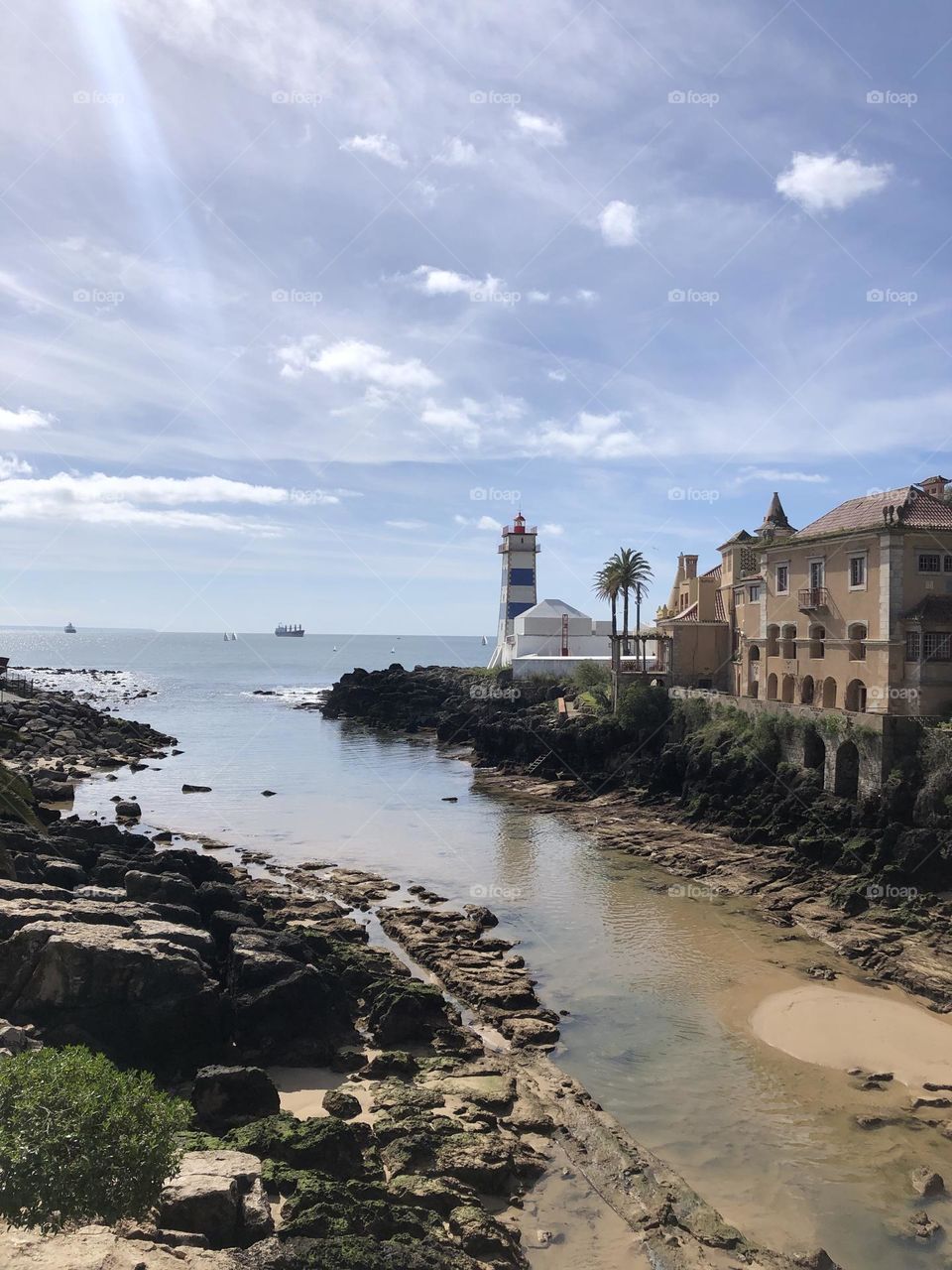 Sunlight at the lighthouse, the water and a blue sky 