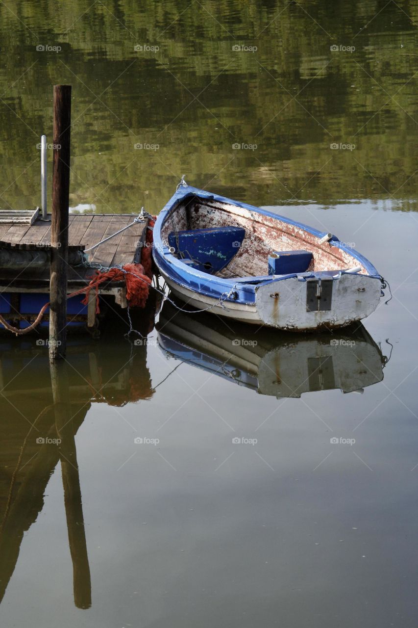 Floating Alone - a small boat at Marievale dam awaiting to be boarded.