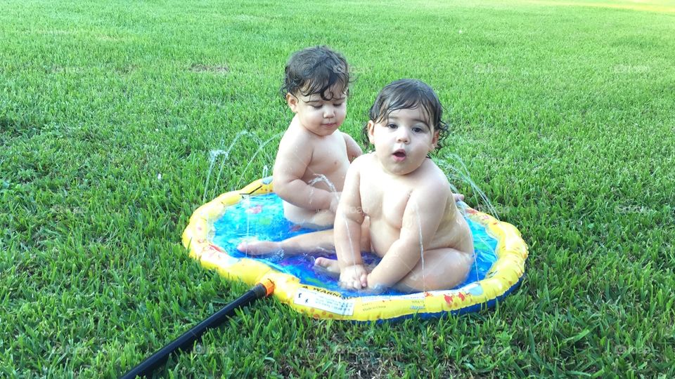 Playing in the sprinklers