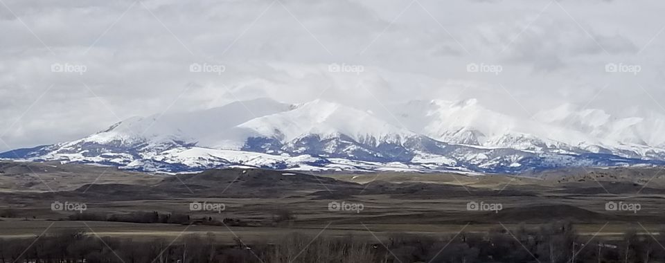 crazy mountains of Montana,  white snow capped and snow still accumulating in April