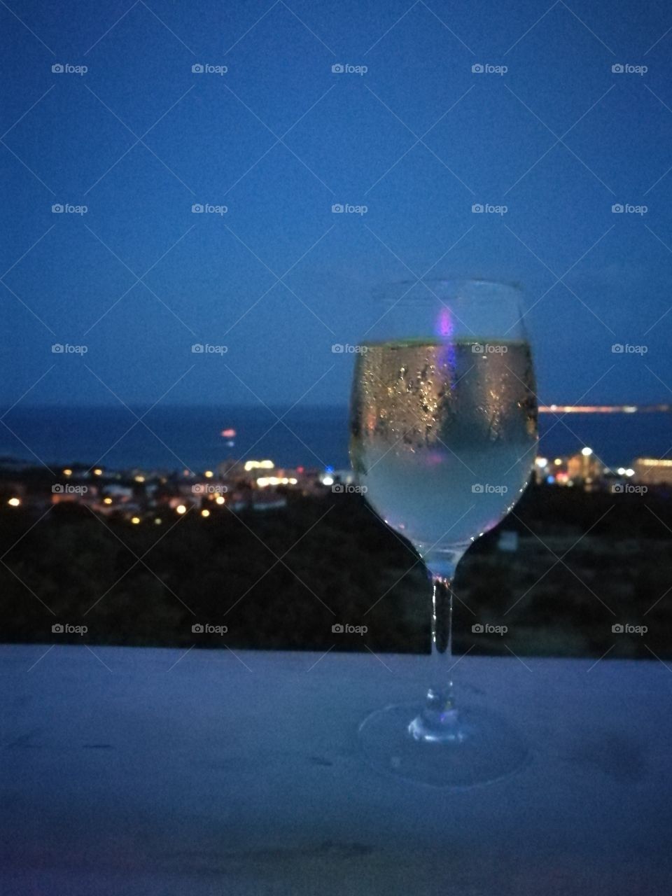 a glass of white wine in bulgaria! in the backround an amazing viwe of the city!