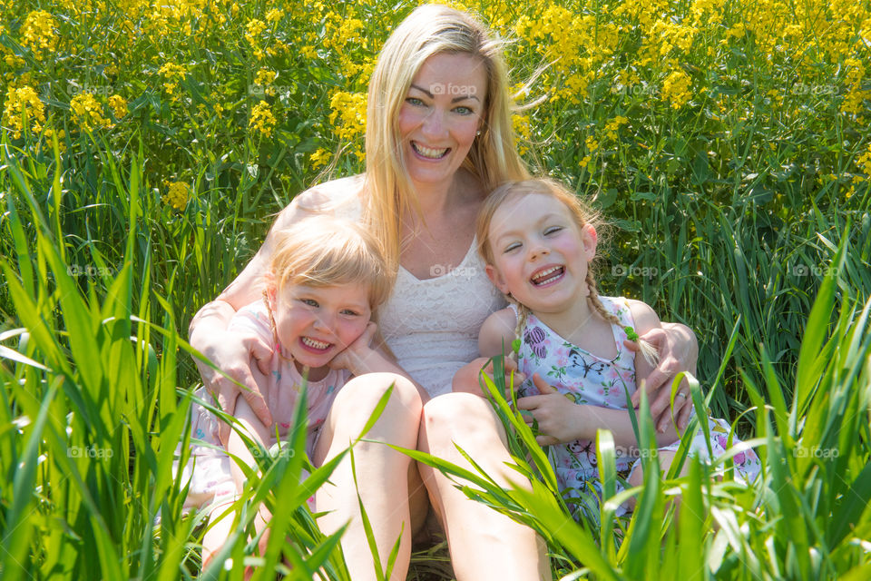 Mother with her two cute doughters posing in a raps field outside Malmö in Sweden.