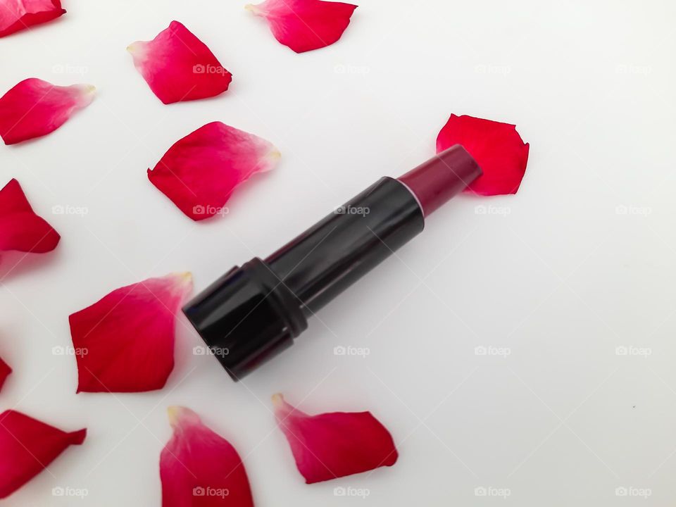 Lipstick with rose petals around