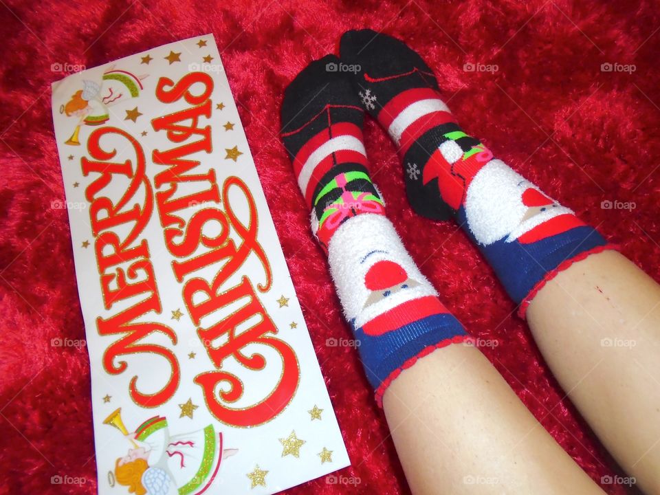 Christmas socks with "Merry Christmas "sign on the carpet