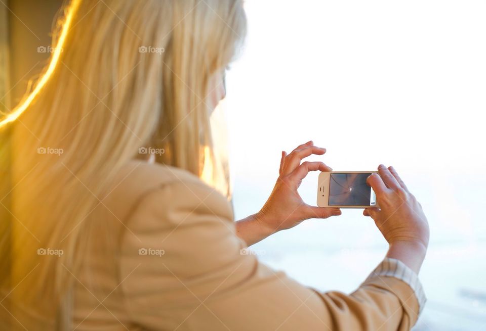 Woman taking photo with smart phone