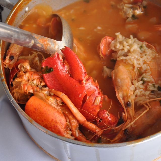 A warm pot of paella full of the freshest seafood. Shrimp, giant lobster claws, clams, rice and a savory broth 