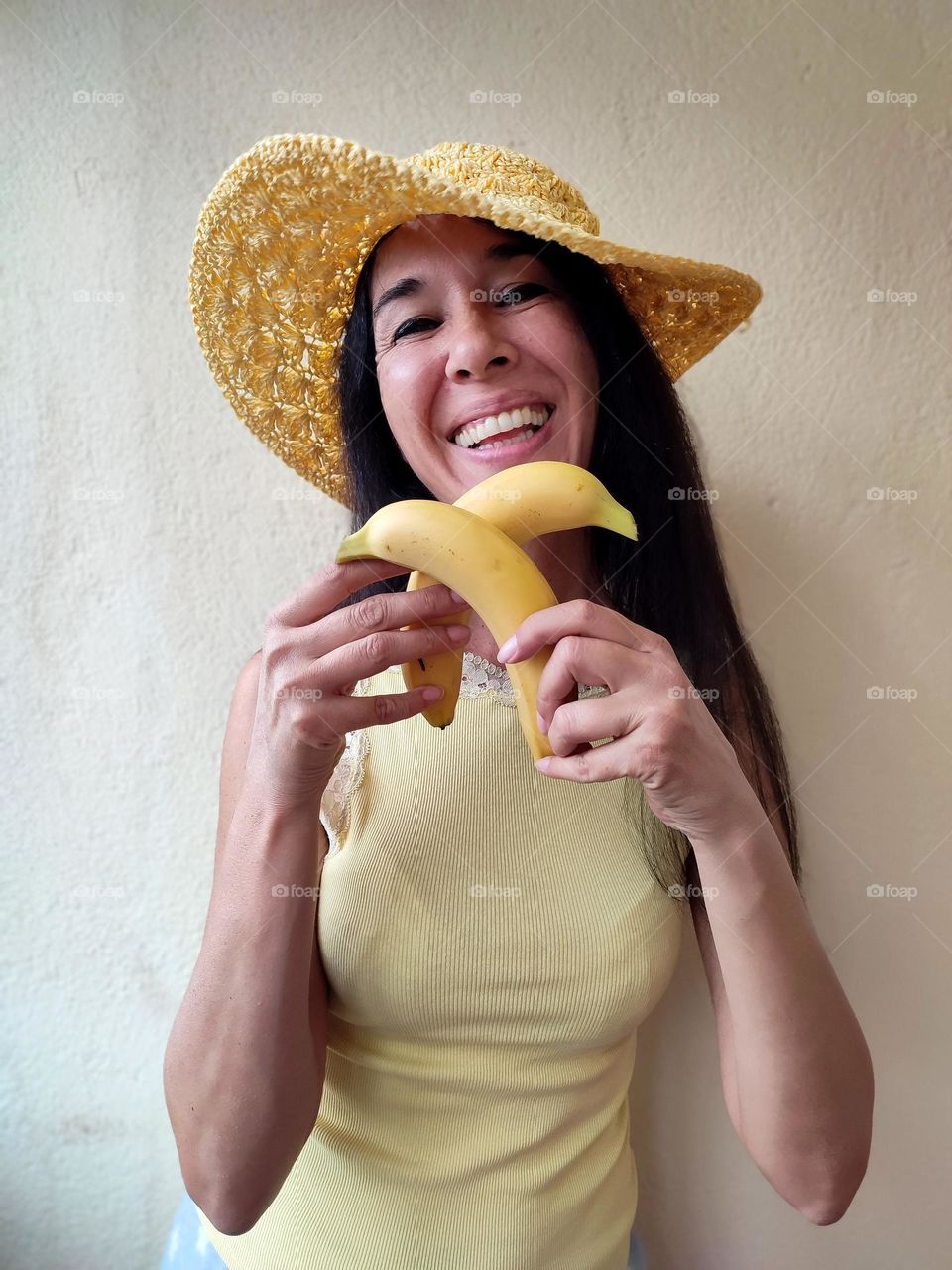 Funny Portrait of Beautiful Smiling Woman with bananas