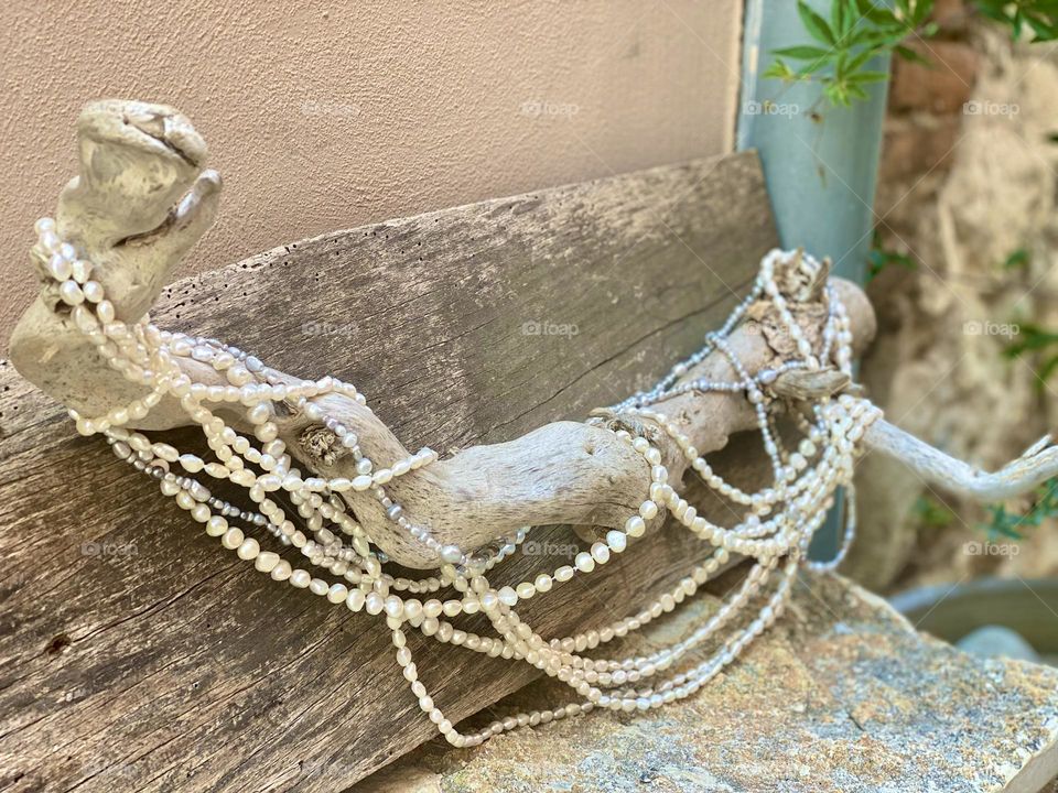 handmade pearl necklace decoration on wood