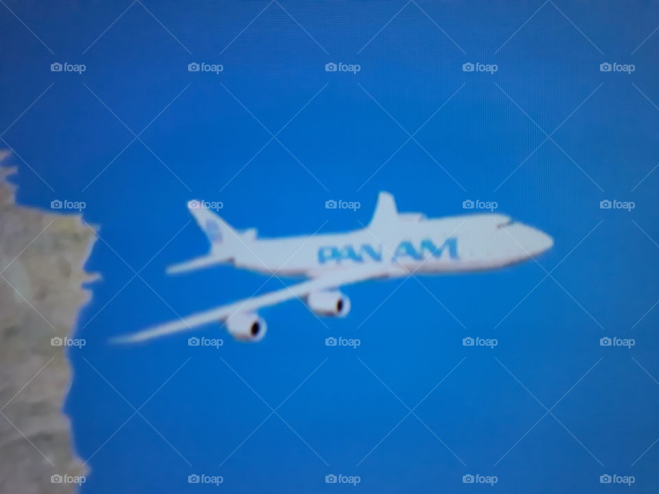 A plane after its takeoff making its radical maneuver in that immense blue sky a beautiful landscape