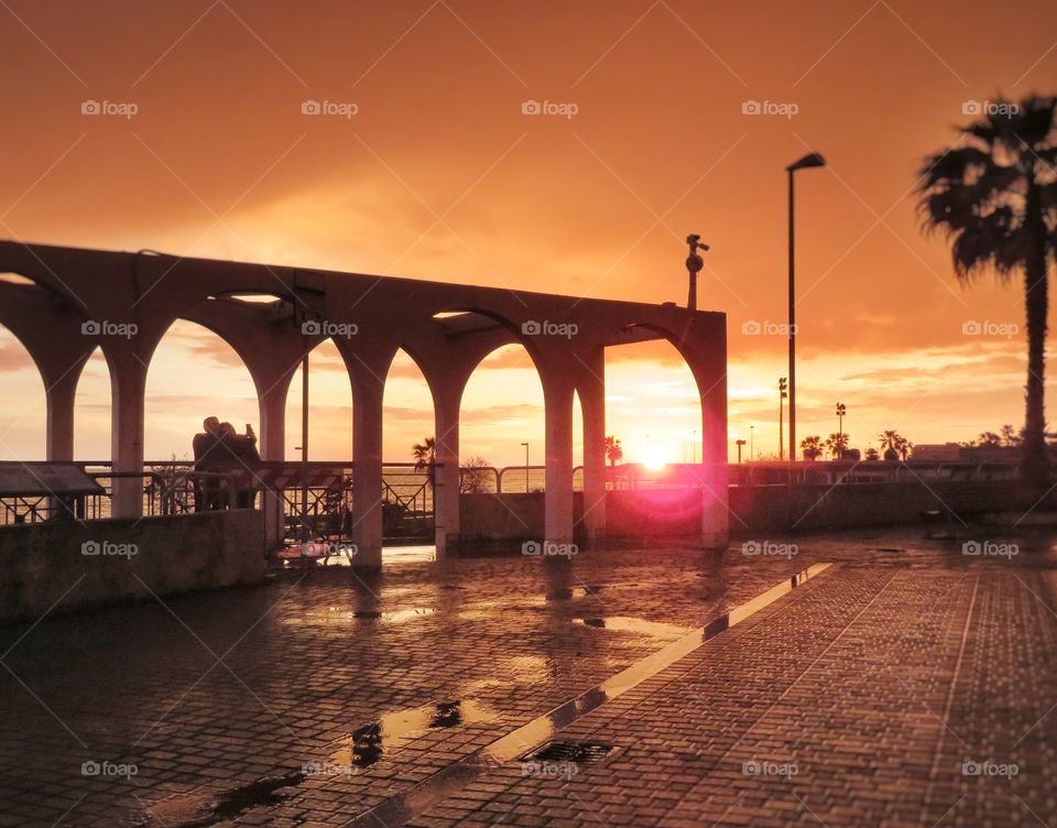 no filtered. lovers taking a selfie during sunset golden hour. Civitavecchia Italy