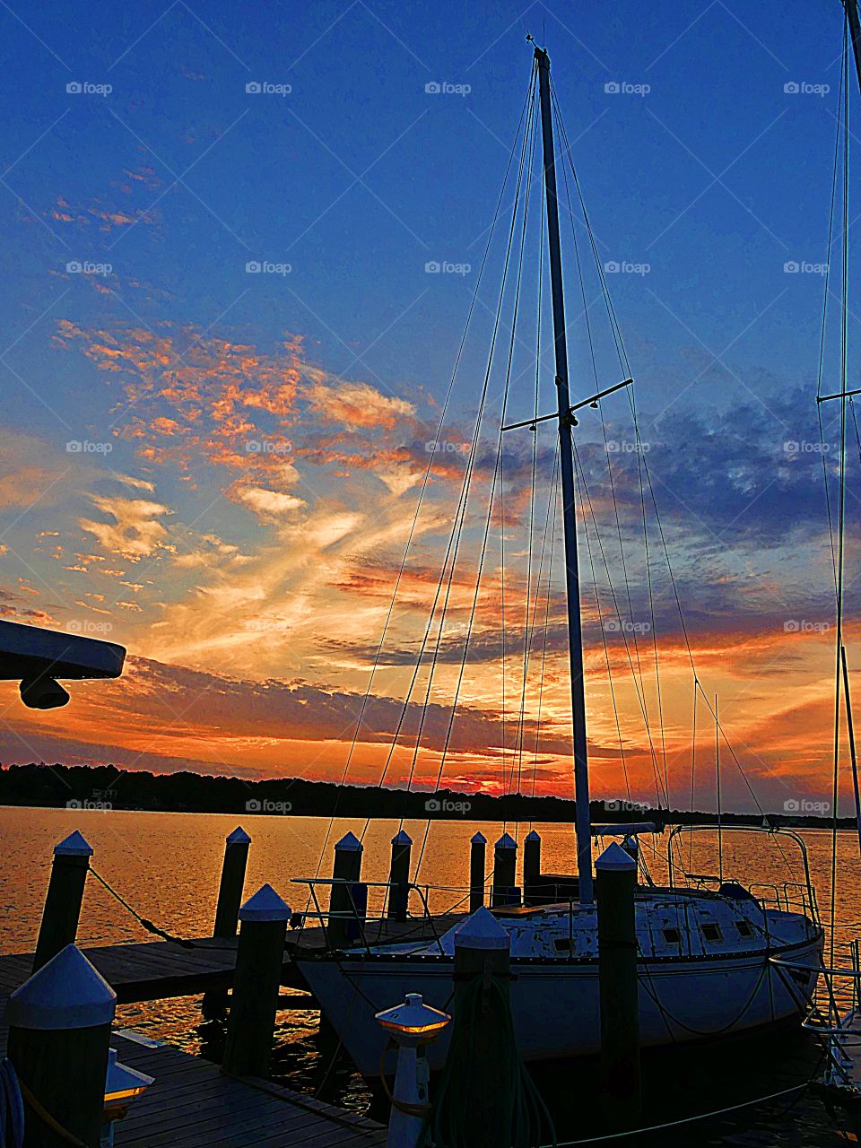 Sailboats at the dock during a spectacular, colorful, vibrant sunset