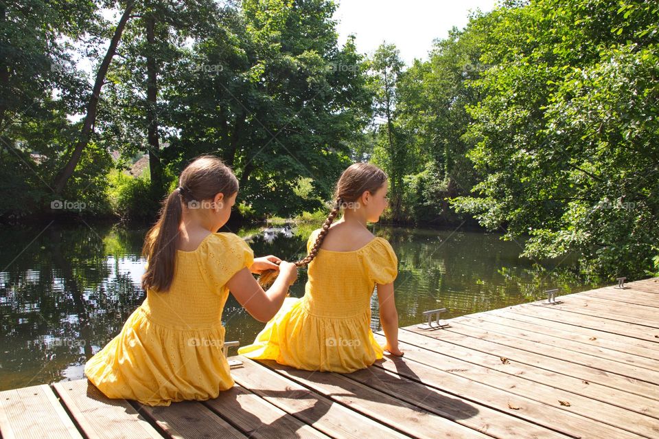 Two girls in yellow dresses