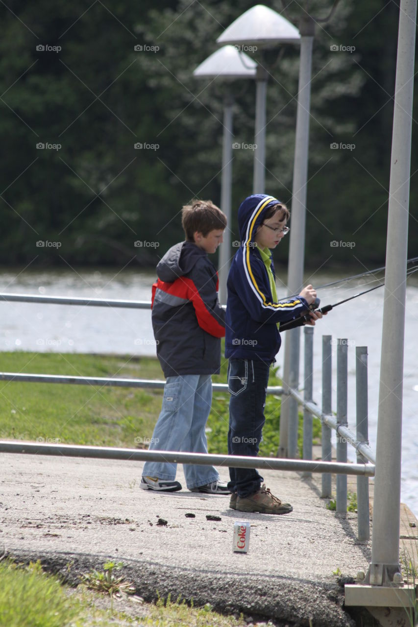 Two boy fishing on lake