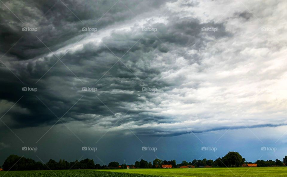 Dark threatening storm clouds rolling in over a Countryside landscape 