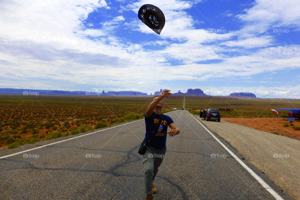 Cowboy is throwing his hat to the sky on the I 163,Utah