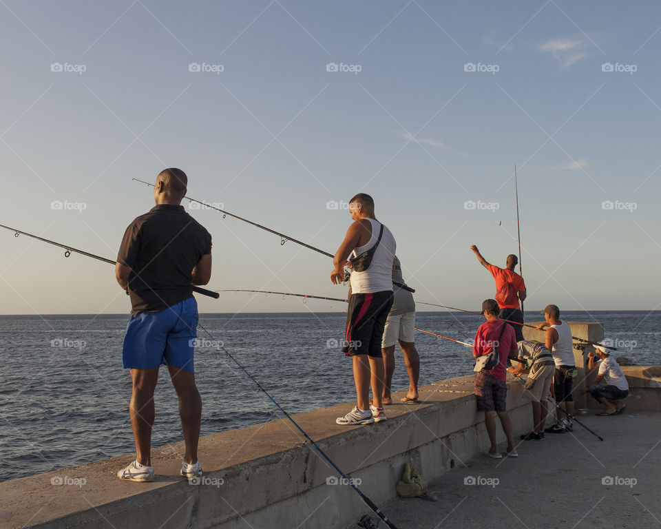 Havana residents fishing in the Malecón, Cuba. 