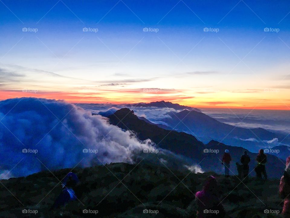 sunrise above the clouds over the mantiqueira mountains in brazil beautiful morning with sun and colorful sky lots of vegetation on the mountains a wonderful view of the mountain chain