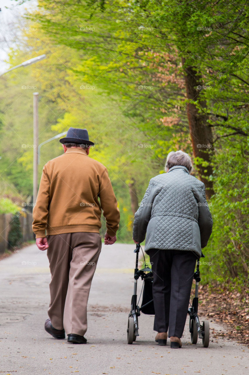 Two man walking on the road