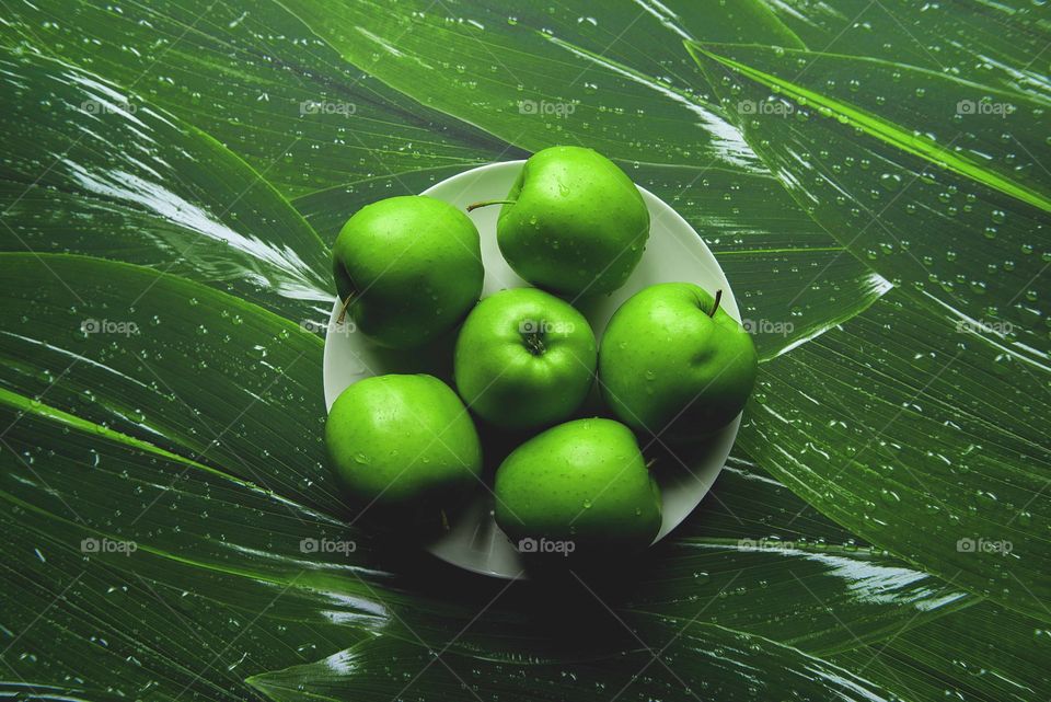 Green apples on green background