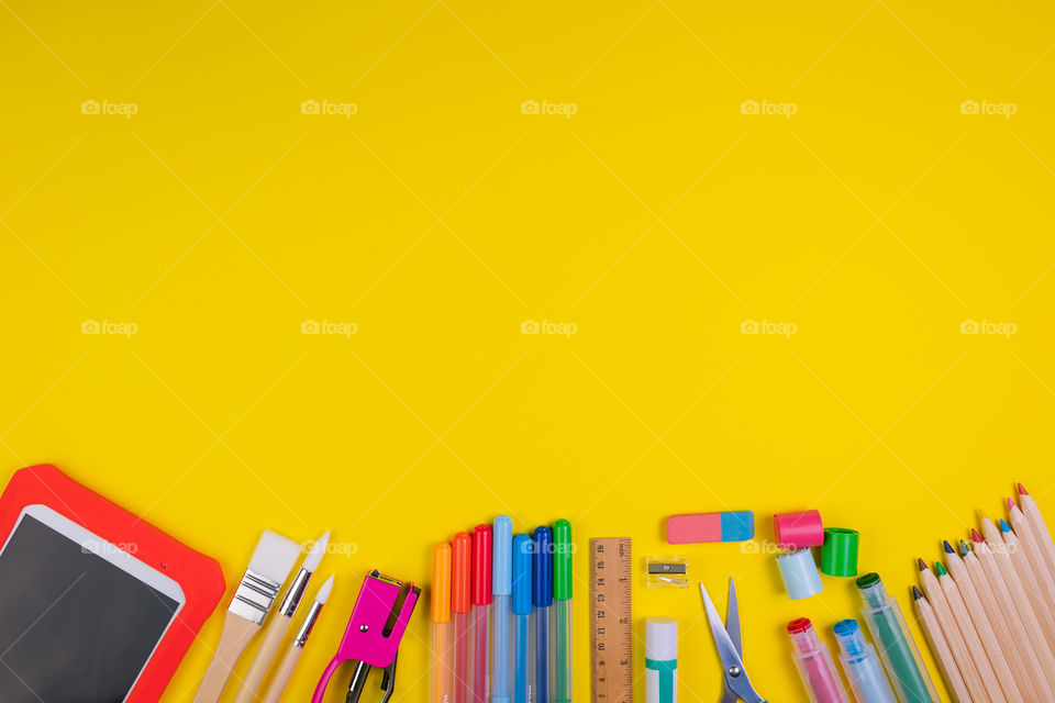 Set of school items on orange background. Back to school concept. Top view. Copy space