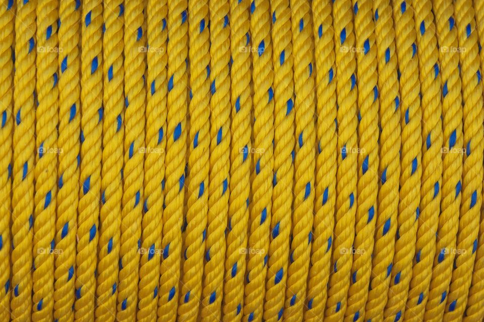 Yellow braided rope on a spool for sale in San Miguel de Allende, Mexico.