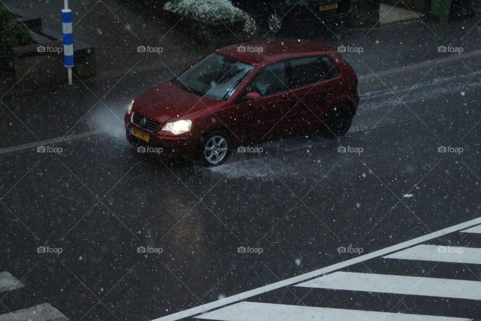 A red car splashing through water!