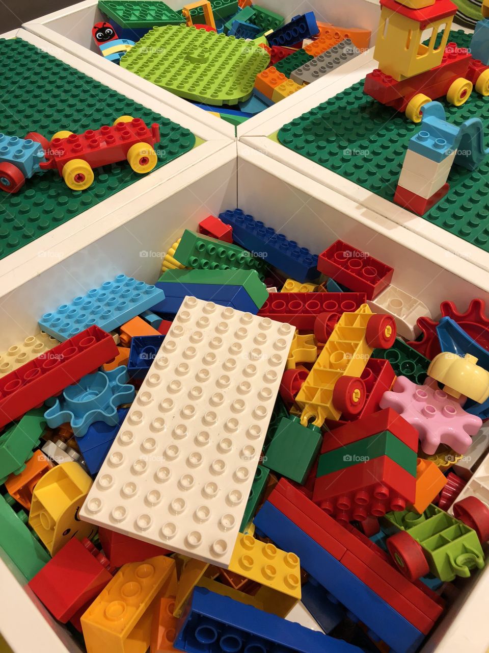 LEGO pieces in white containers