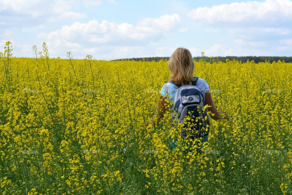woman in rapeseed field summer vacation