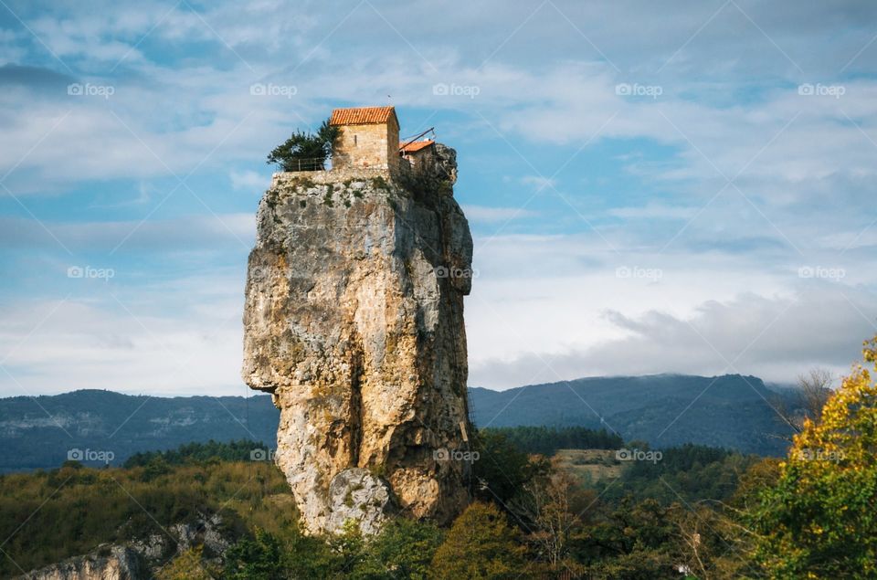 Katskhi pillar. Georgian landmarks. Man's monastery near the village of Katskhi. The orthodox church and the abbot cell on a rocky cliff. Imereti, Georgia. Georgian Meteora