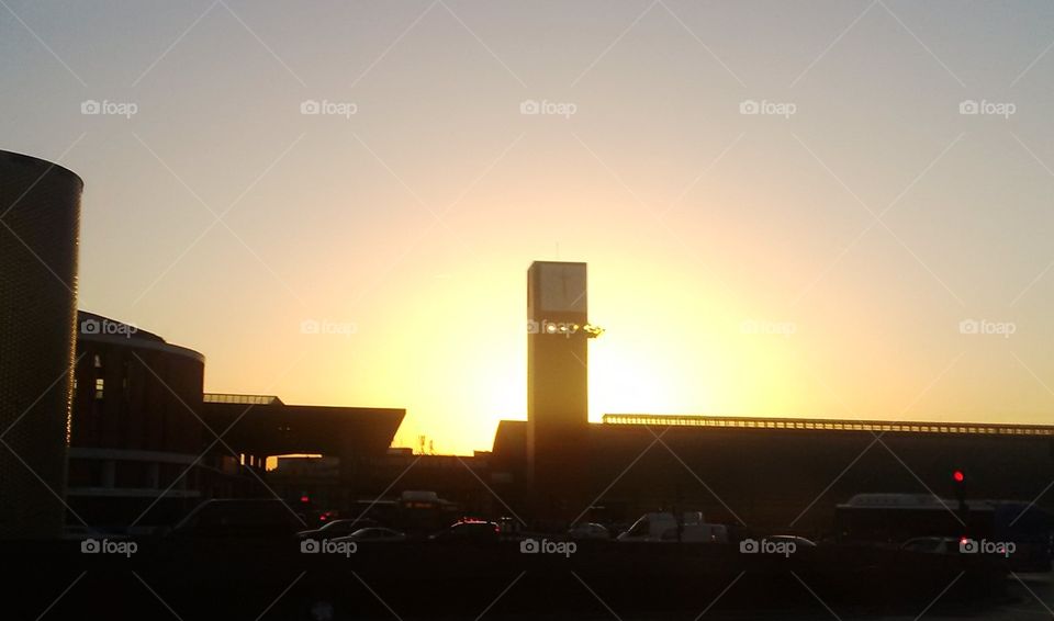 The setting sun behind the clock tower of Madrid's Atocha rail station.