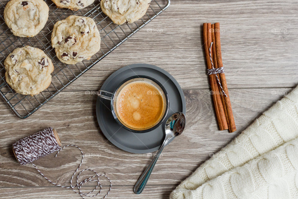 High angle view of cup of coffee with cookies